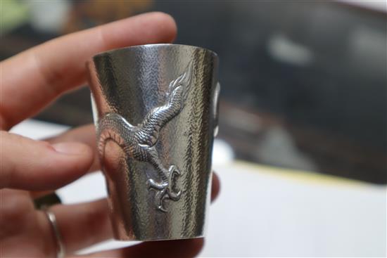 A set of nine early 20th century Chinese Export white metal tots, by Zee Wo, each decorated with a dragon, 13 oz.
